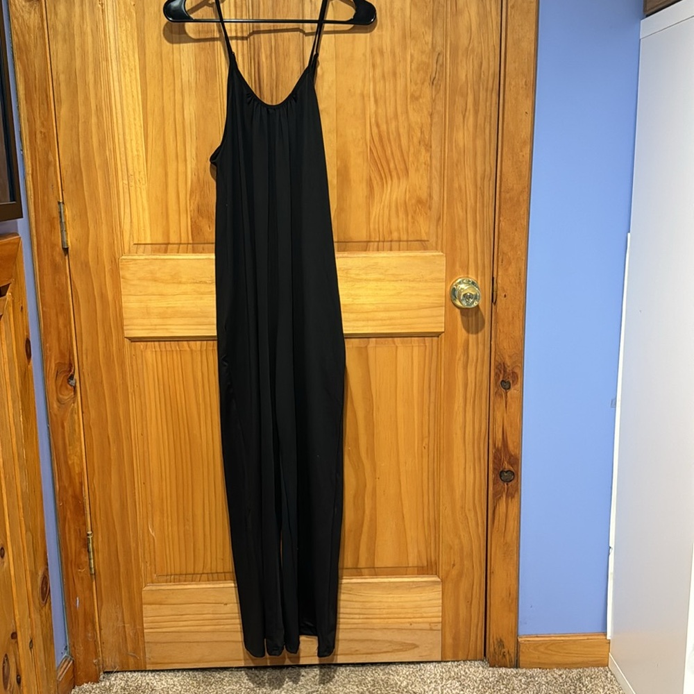Black romper with spaghetti straps has pockets